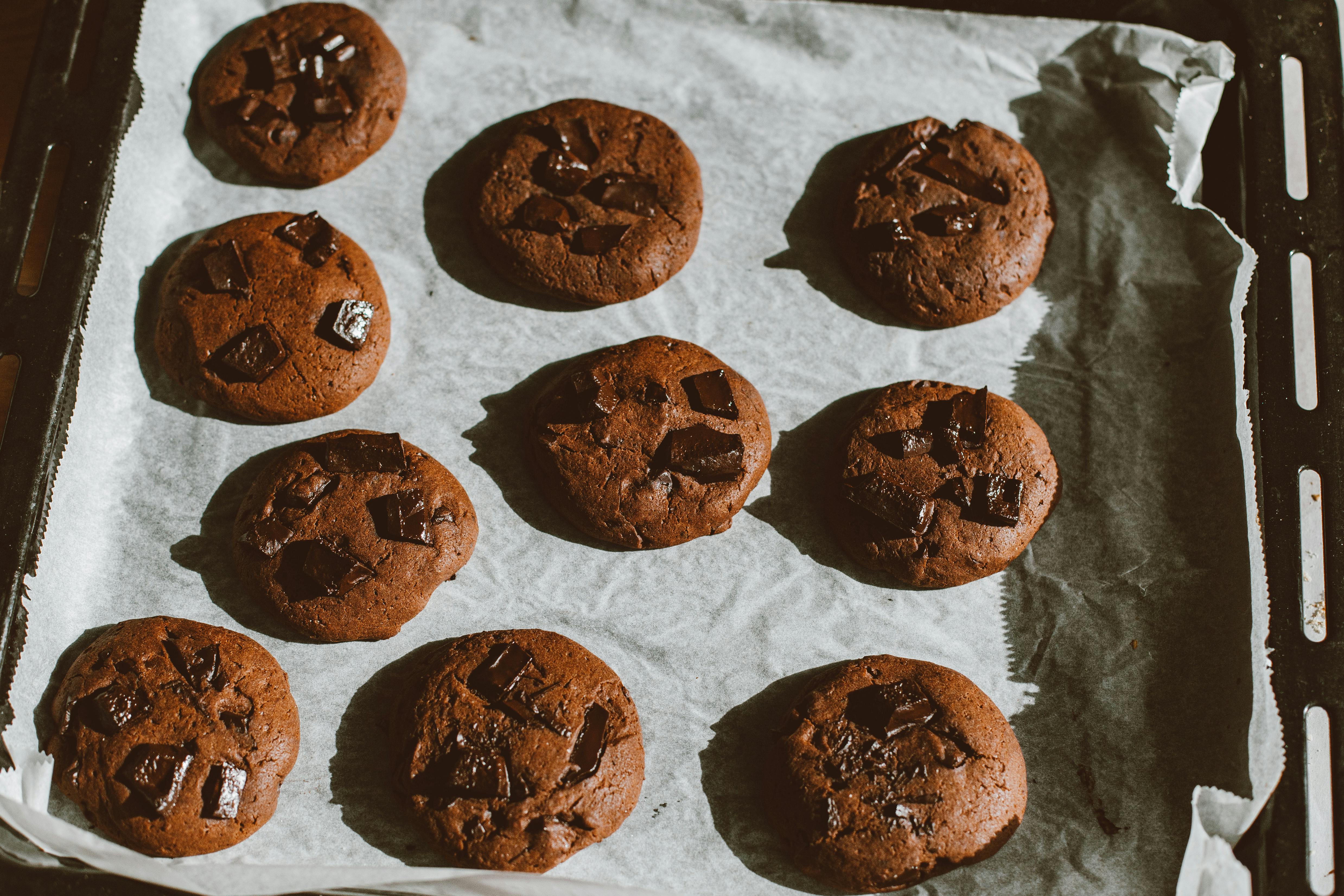 Overhead view of chocolate cookies on parchment-lined baking tray