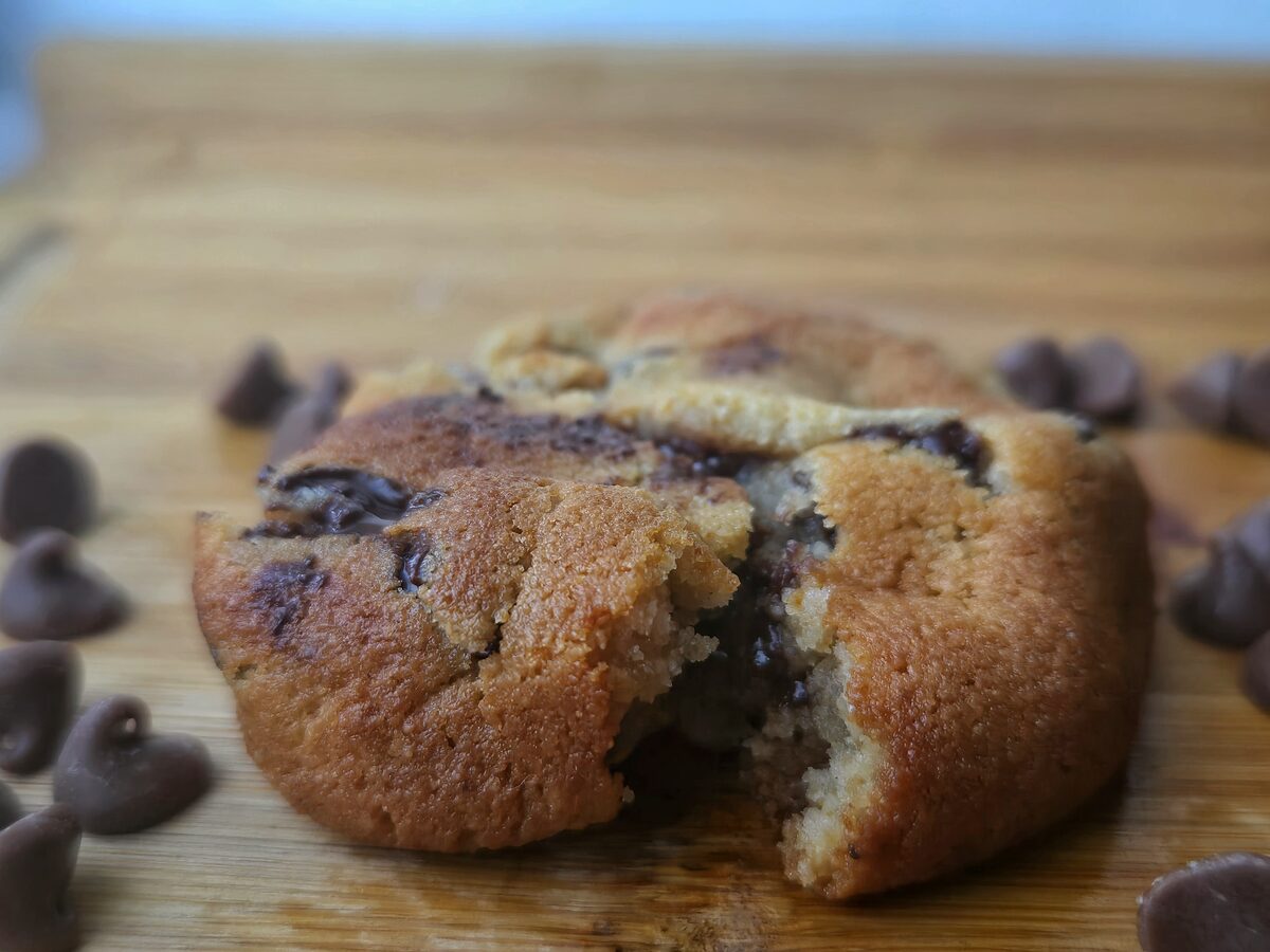 A hush cookie broken open, soft centre and melted chocolate.